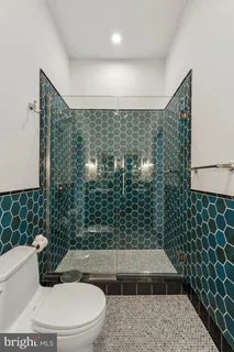 a bathroom with a toilet and a shower
