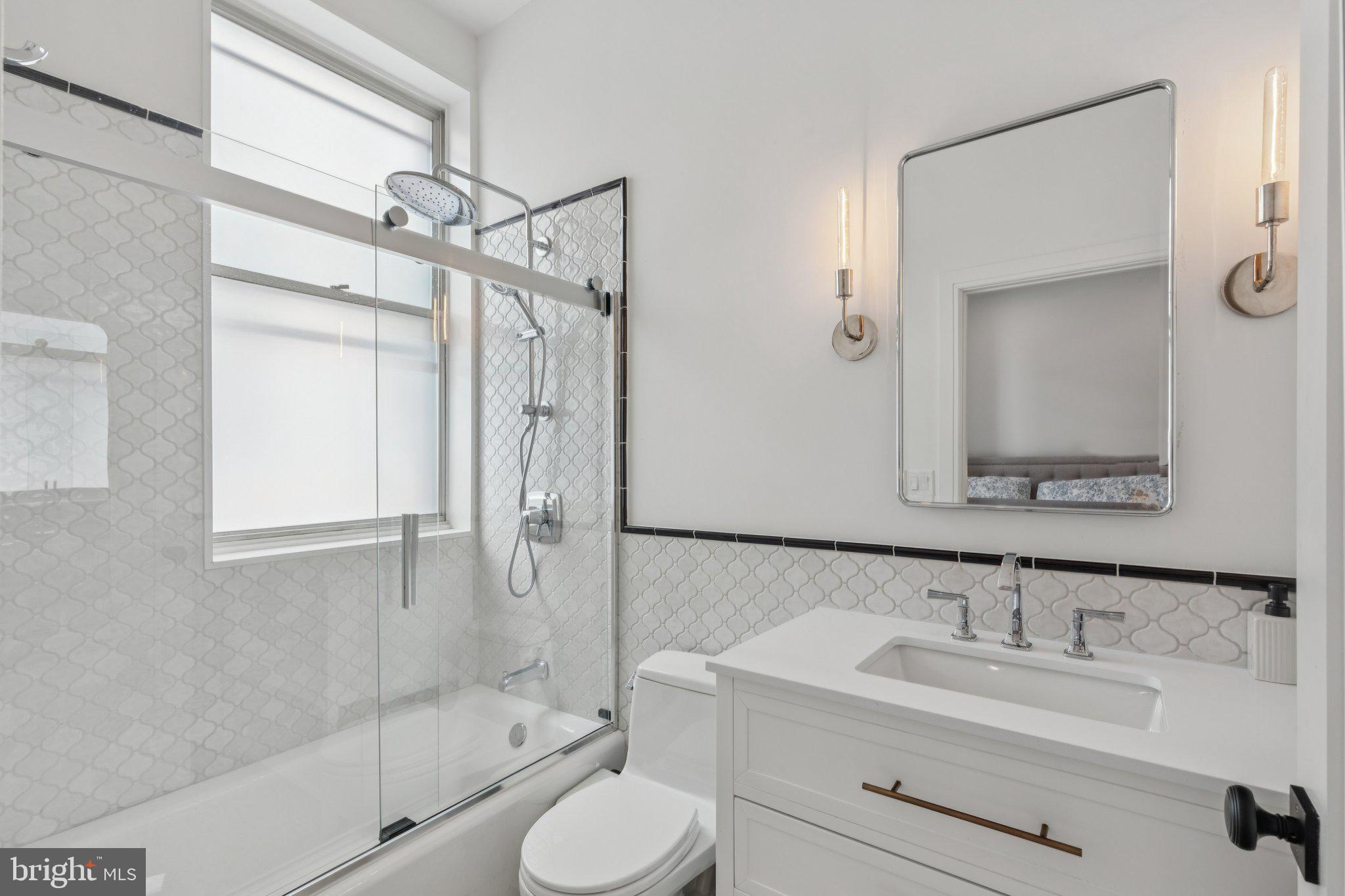 207 South 24th Street Philadelphia, PA 19103 - Photo 33 of 47 a bathroom with a sink toilet a mirror and shower