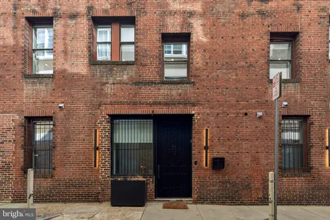 a front view of a brick house with a door