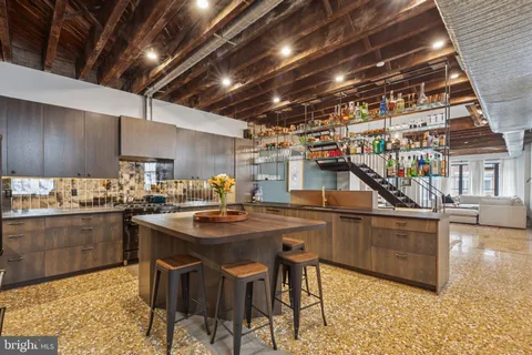 a kitchen with stainless steel appliances granite countertop a sink and cabinets