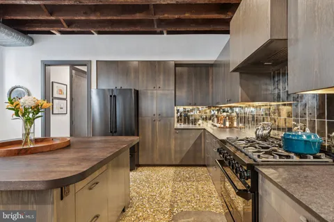 a kitchen with stainless steel appliances granite countertop a stove and a refrigerator