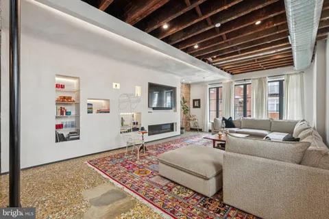 a living room with furniture and a rug