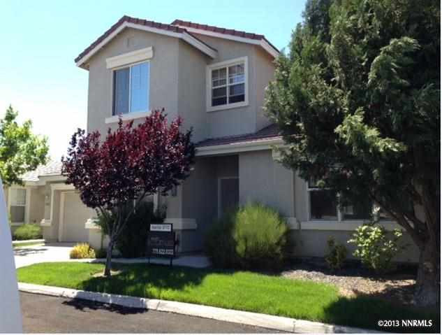 10457 Chadwell Drive Reno, NV 89521 - Photo 1 of 1 a house that has a tree in front of the house
