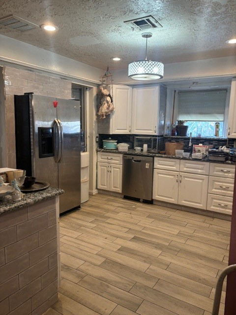 4807 Redfish Reef Drive Bacliff, TX 77518 - Photo 5 of 16 a kitchen with stainless steel appliances granite countertop a sink a stove and a refrigerator