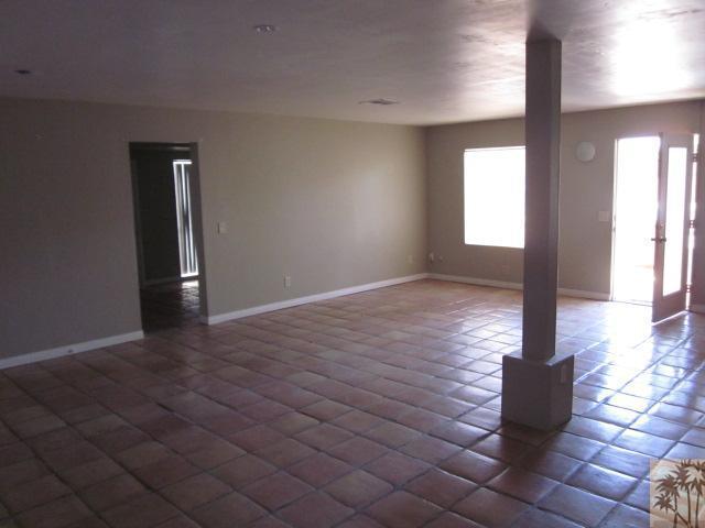 71966 Vista Del Rio Rancho Mirage, CA 92270 - Photo 20 of 23 an empty room with wooden floor and windows