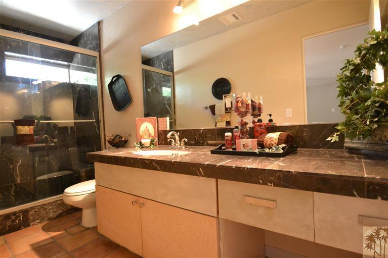71966 Vista Del Rio Rancho Mirage, CA 92270 - Photo 7 of 23 a bathroom with a granite countertop sink a toilet and a mirror