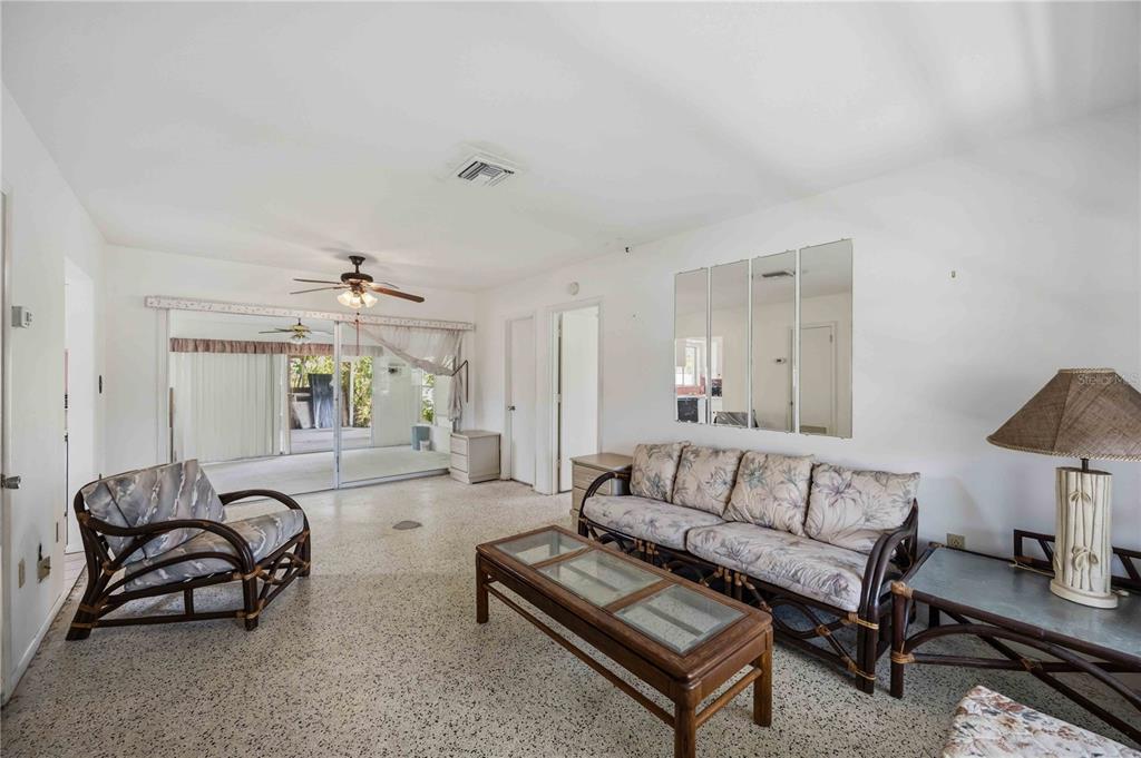 309 Base Avenue East Venice, FL 34285 - Photo 13 of 36 a living room with furniture and a chandelier