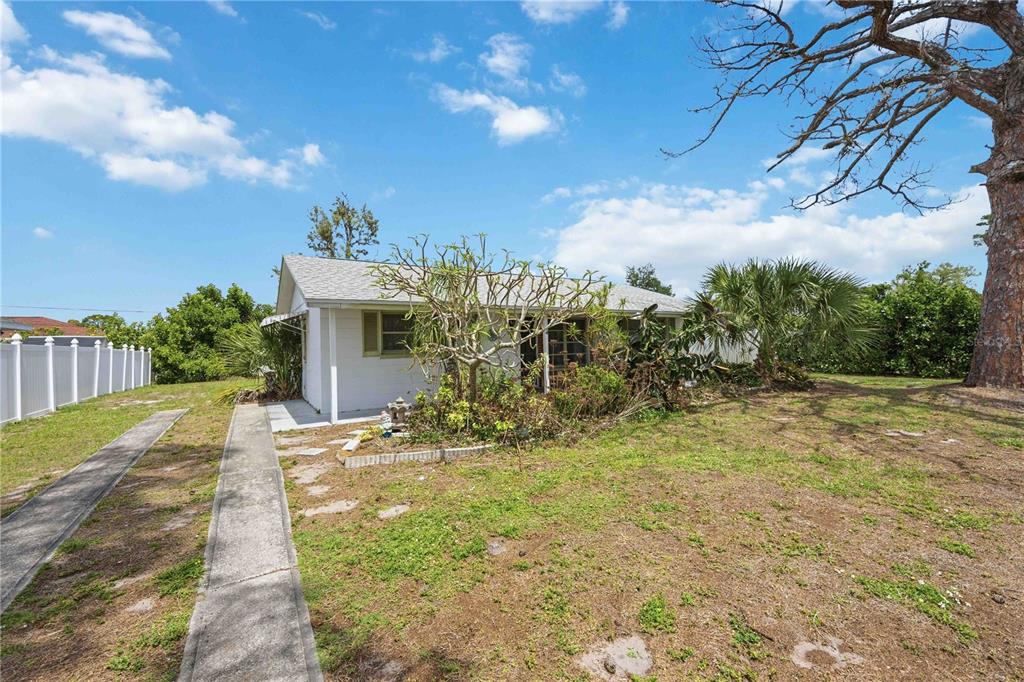 309 Base Avenue East Venice, FL 34285 - Photo 2 of 36 a view of a house with a yard
