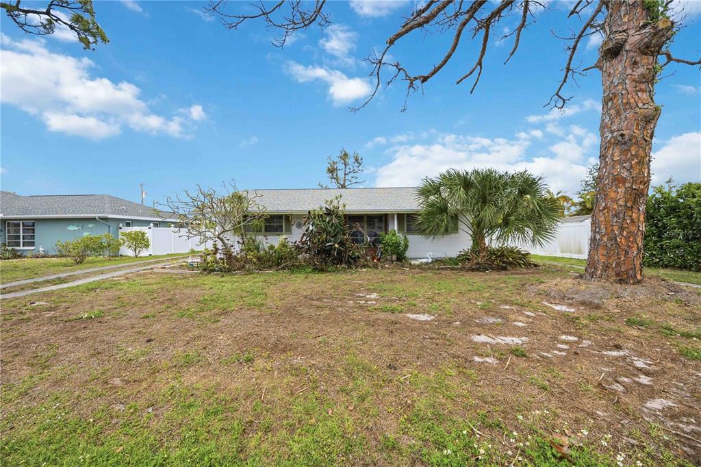 309 Base Avenue East Venice, FL 34285 - Photo 6 of 36 a view of a house with a yard