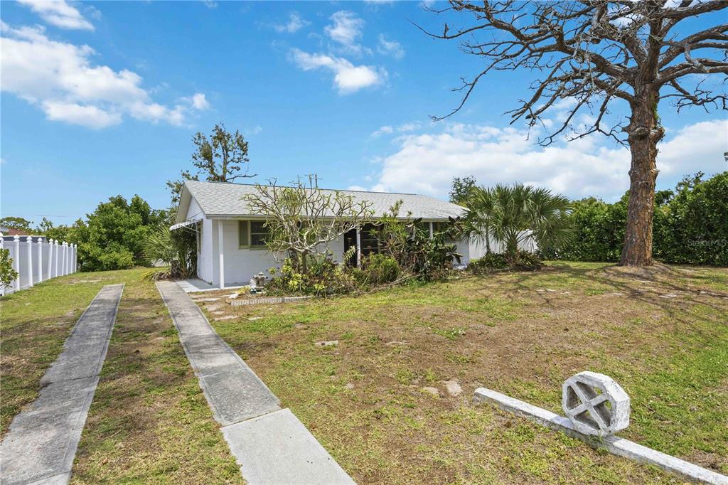 309 Base Avenue East Venice, FL 34285 - Photo 8 of 36 a front view of a house with a yard