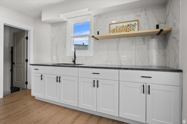 327 35th Street Ogden, UT 84401 - Photo 16 of 31 White shaker cabinetry with dark hardware, dark speckled countertops, and a white marble-look tile backsplash