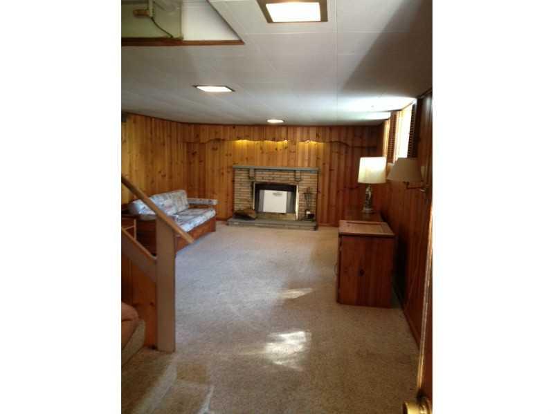 1235 Varner Road Whitehall, PA 15227 - Photo 12 of 18 Family Room. The spacious game room has a log burning fireplace and is ready for fun!