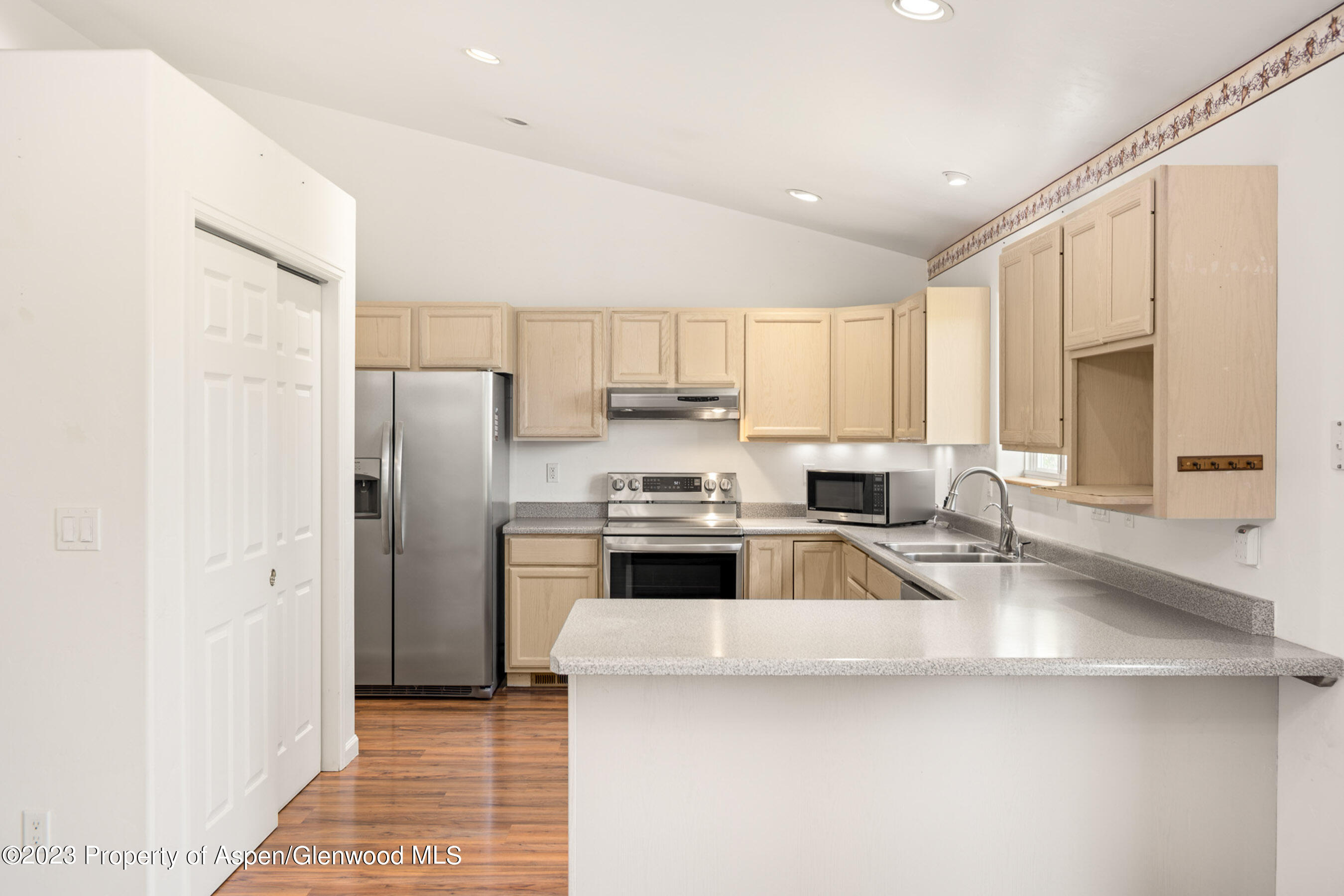 1350 Firethorn Drive Rifle, CO 81650 - Photo 3 of 34 a kitchen with a refrigerator sink and cabinets