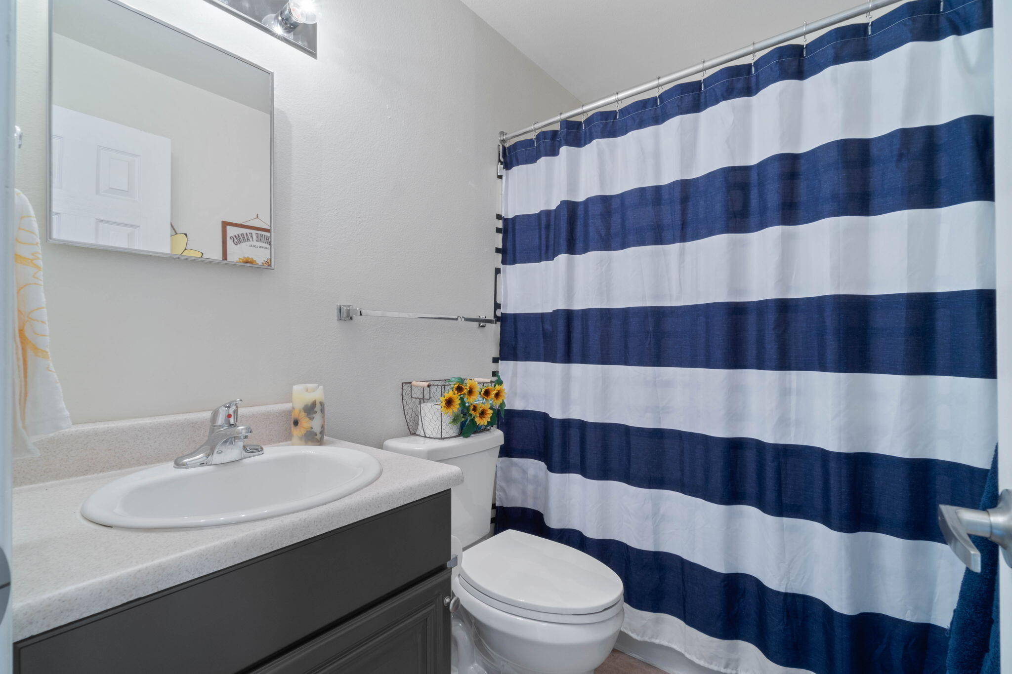 565 Wingspan Way Crestview, FL 32536 - Photo 23 of 39 a bathroom with a sink a toilet a window and a mirror