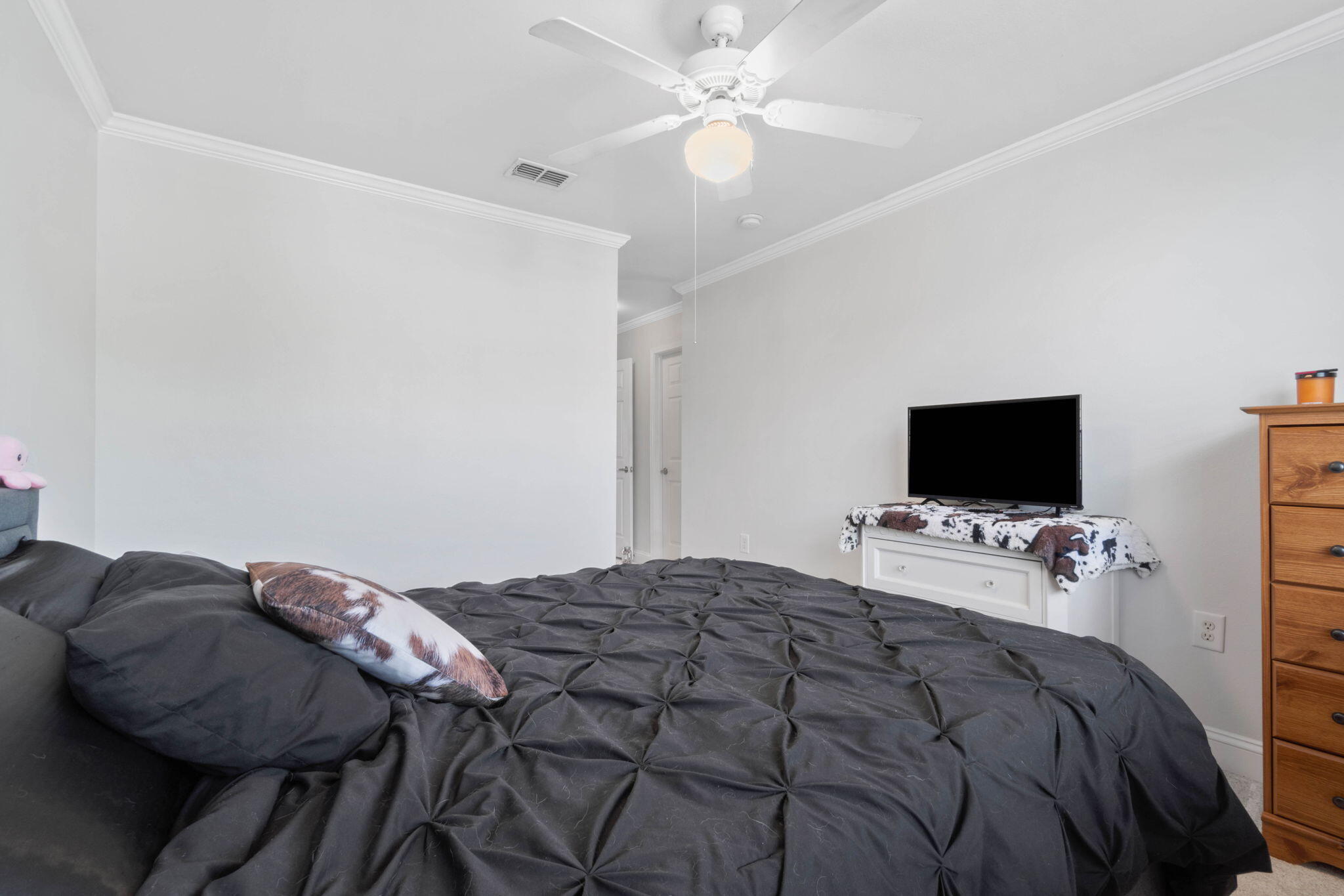 565 Wingspan Way Crestview, FL 32536 - Photo 27 of 39 a bedroom with a bed and a flat screen tv
