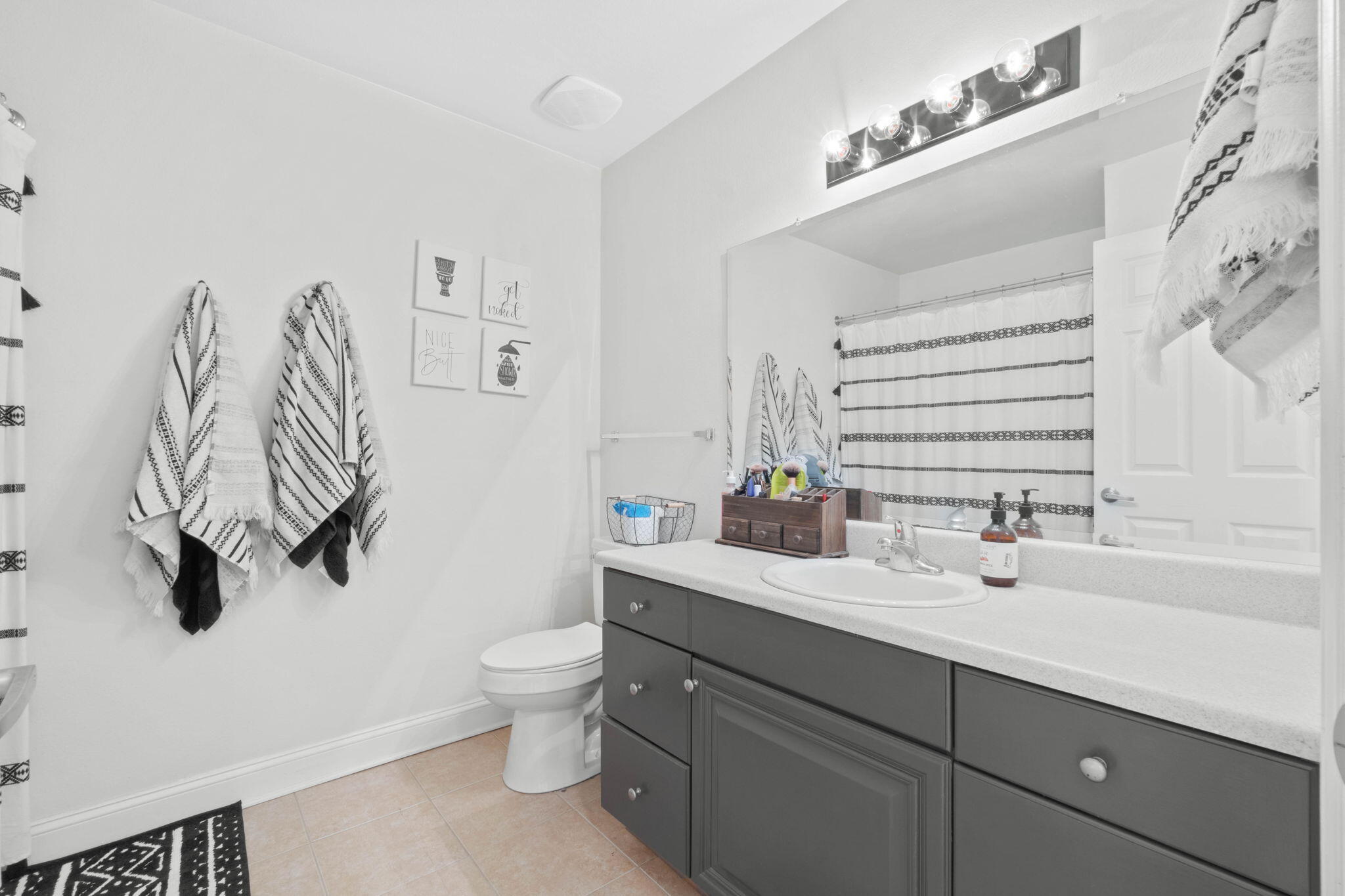 565 Wingspan Way Crestview, FL 32536 - Photo 28 of 39 a bathroom with a sink a toilet and a mirror