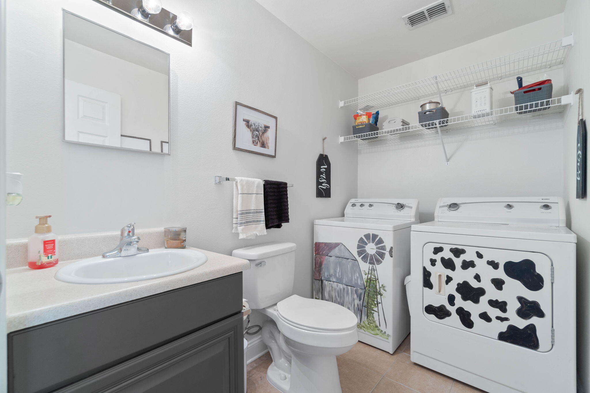 565 Wingspan Way Crestview, FL 32536 - Photo 8 of 39 a bathroom with a sink toilet and a mirror