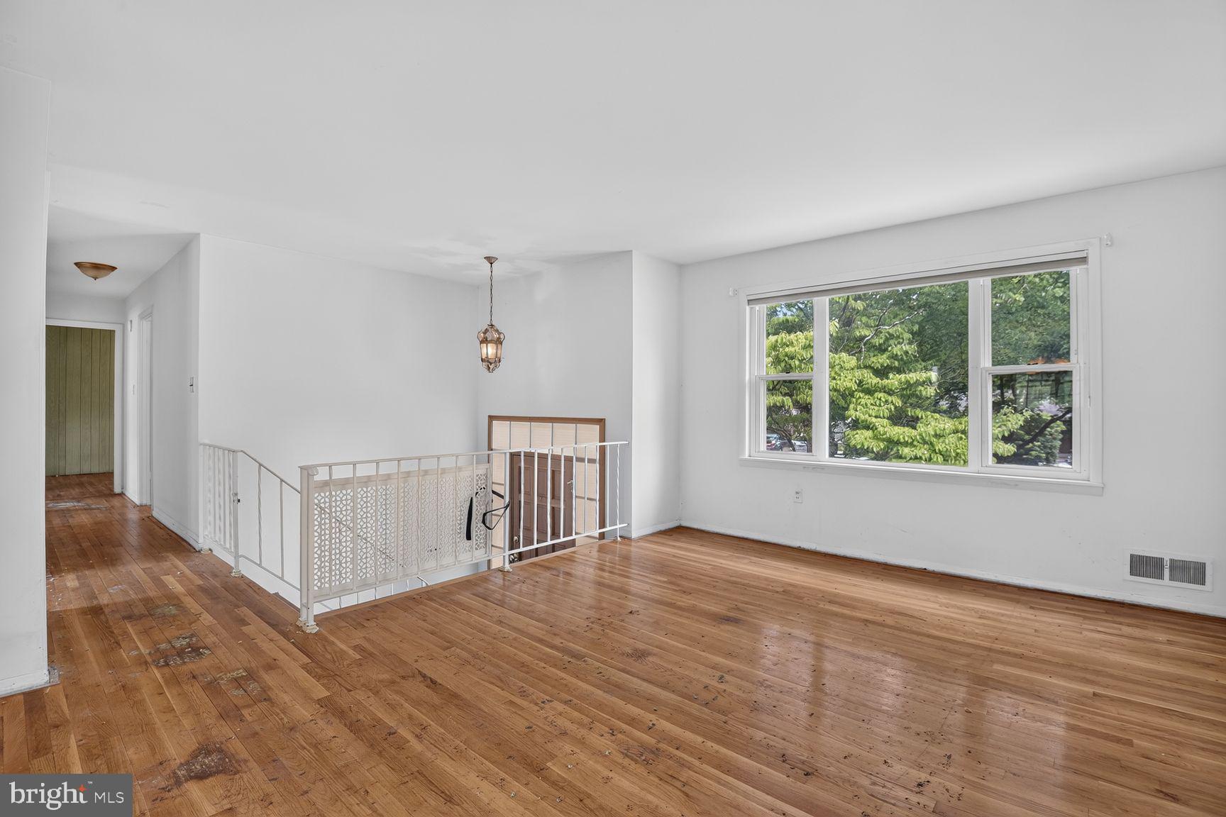 1326 Gresham Road Silver Spring, MD 20904 - Photo 11 of 30 a view of an empty room with wooden floor and a window