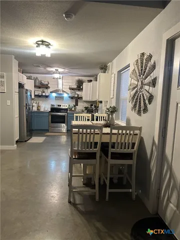 a white toilet sitting next to a bathroom sink