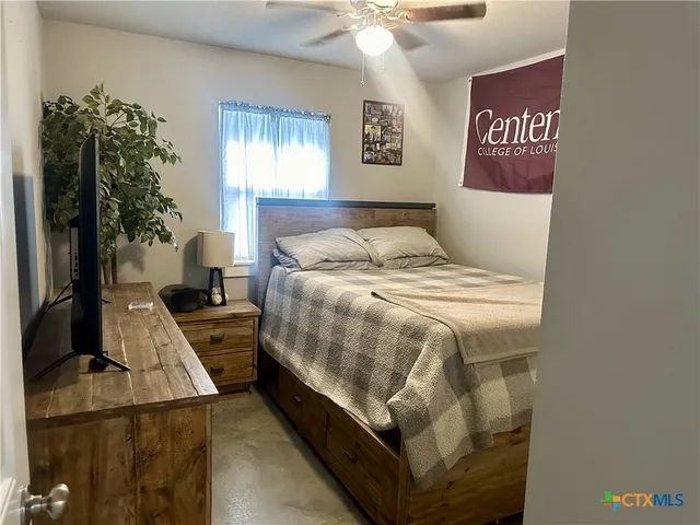 a bathroom with a granite countertop sink a toilet a mirror and shower