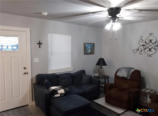 a kitchen with refrigerator and chairs