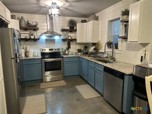 a kitchen with a table and chairs in it