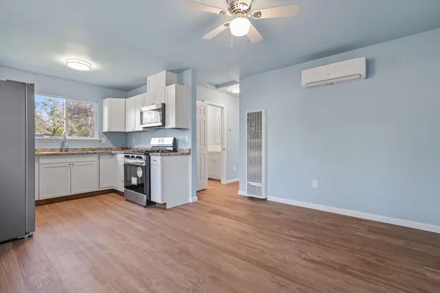 a kitchen with stainless steel appliances a stove top oven and a refrigerator