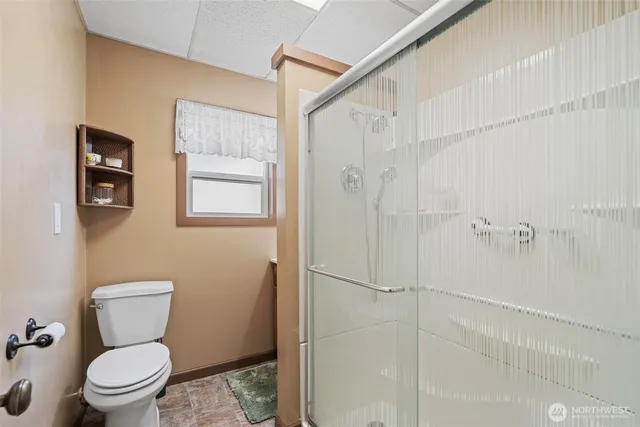 a white toilet sitting next to a bathroom sink