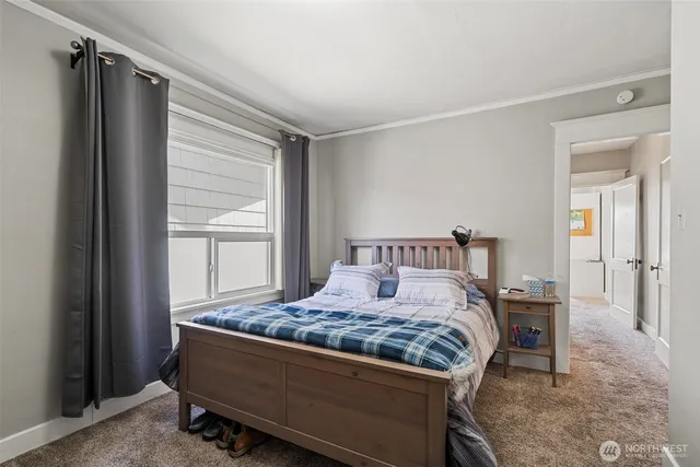 a bedroom with a bed and a window in it