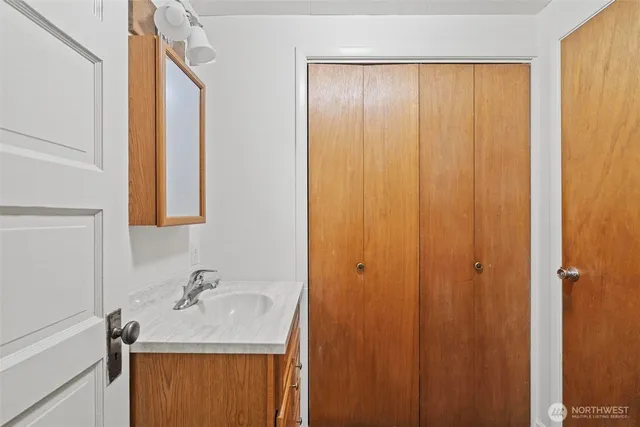 a bathroom with a sink a mirror and shower curtain
