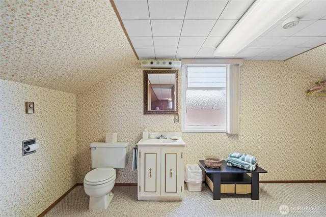 a bathroom with a toilet sink and mirror