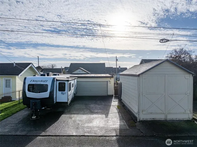 a utility room with dryer washer and storage racks