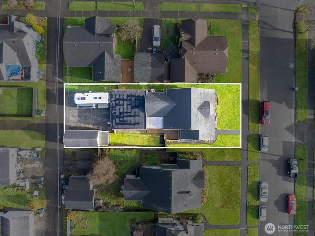 an aerial view of a house with a swimming pool