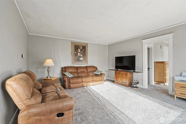 a bedroom with furniture and a flat screen tv