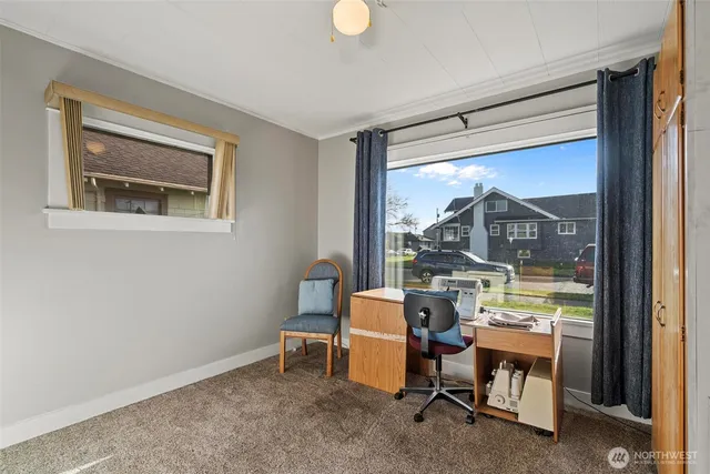 a room with chairs and a window