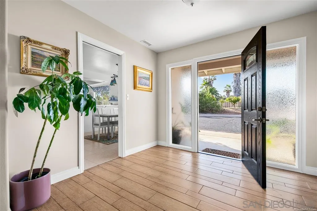 29760 Miller Road Valley Center, CA 92082 - Photo 8 of 25 a view of empty room with wooden floor and plant