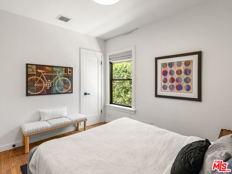 4707 Toland Way Los Angeles, CA 90042 - Photo 13 of 31 a bedroom with a bed and a painting on the wall