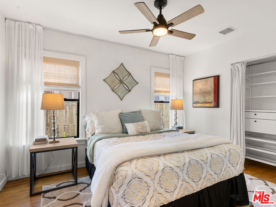 4707 Toland Way Los Angeles, CA 90042 - Photo 15 of 31 a bedroom with a bed and a chandelier