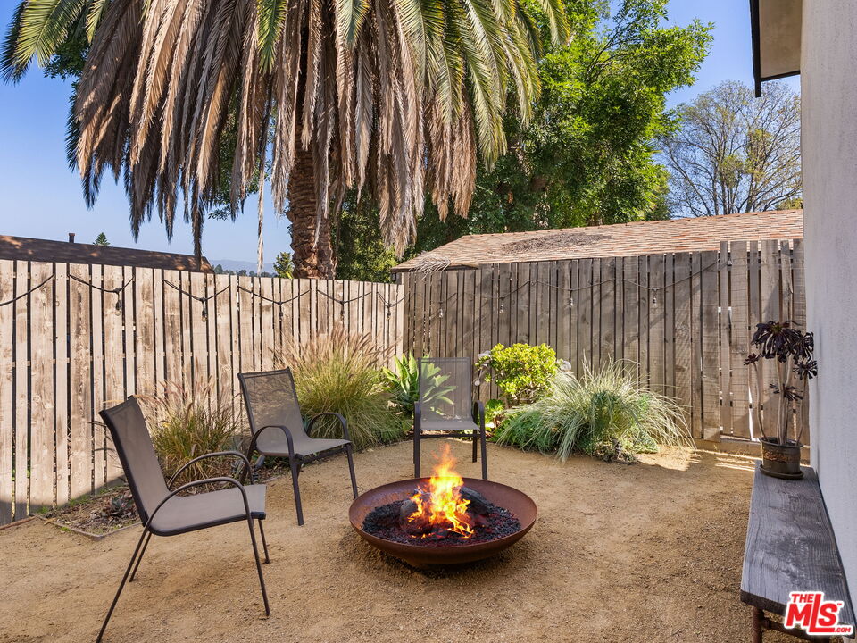 4707 Toland Way Los Angeles, CA 90042 - Photo 26 of 31 a backyard with table and chairs potted plants and wooden fence
