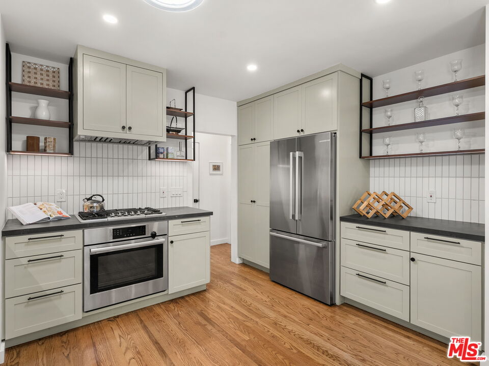 4707 Toland Way Los Angeles, CA 90042 - Photo 8 of 31 a kitchen with wooden floors and stainless steel appliances