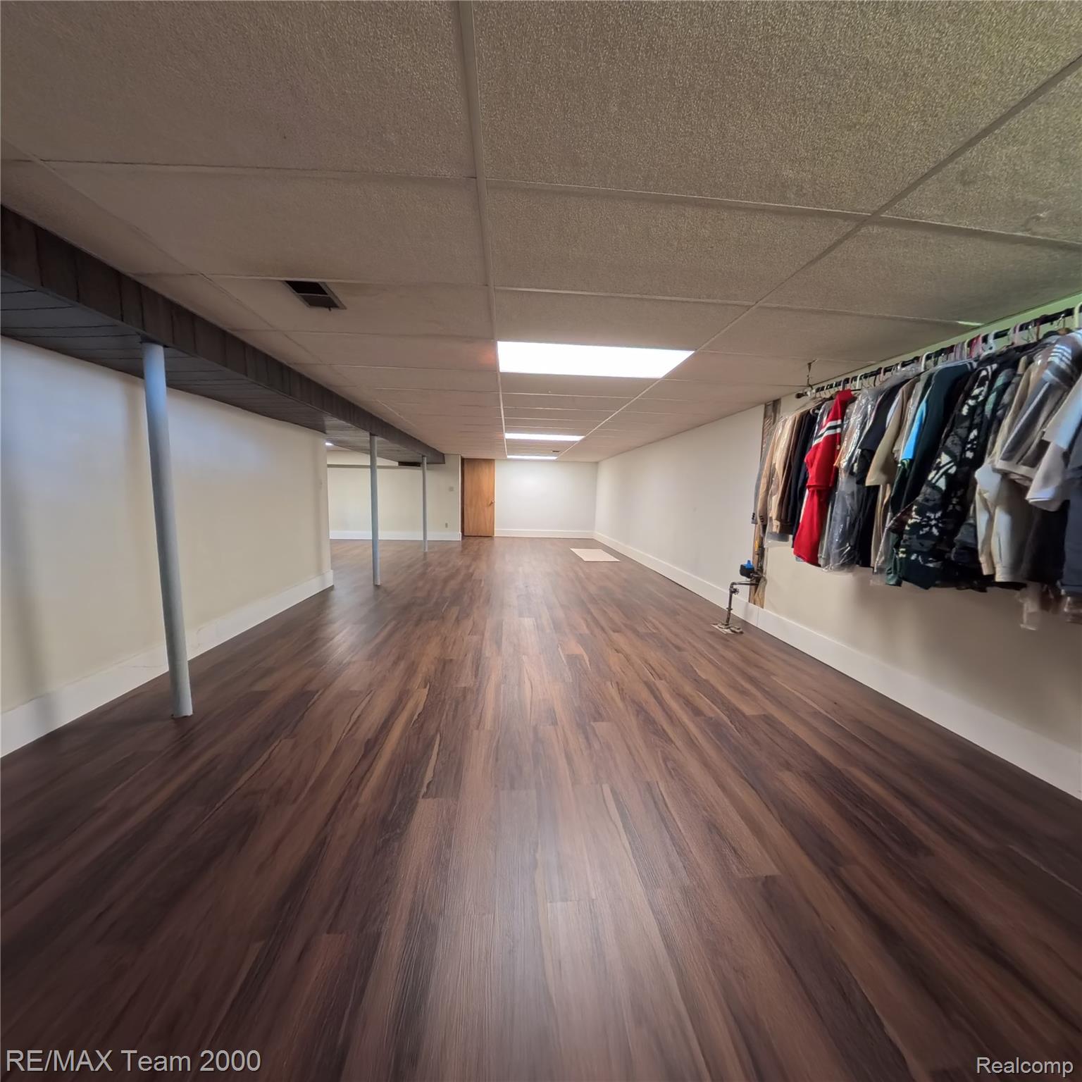 2104 Whittier Road Ypsilanti, MI 48197 - Photo 32 of 45 Finished basement featuring a paneled ceiling and dark wood-style flooring