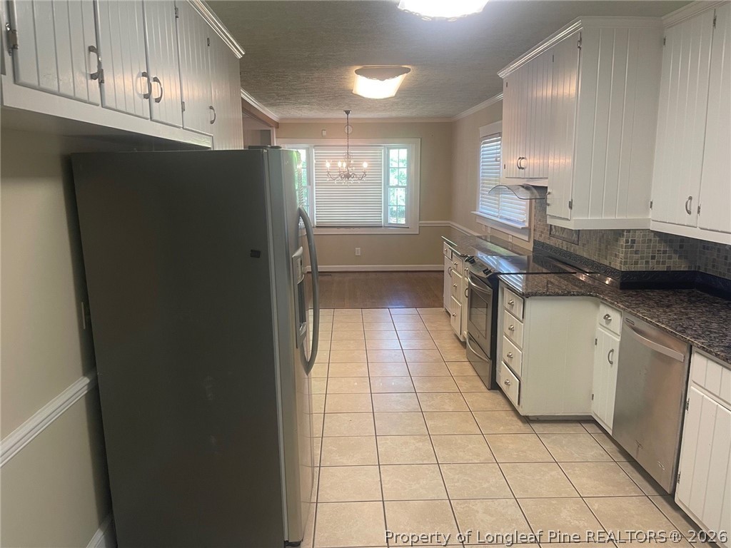 2515 Fort Bragg Road Fayetteville, NC 28303 - Photo 9 of 23 a kitchen with stainless steel appliances granite countertop a refrigerator a sink and white cabinets