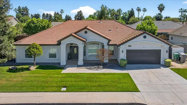 a aerial view of a house with a yard patio and swimming pool