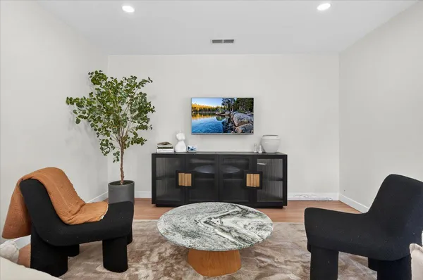 a bedroom with a bed and painting on the wall