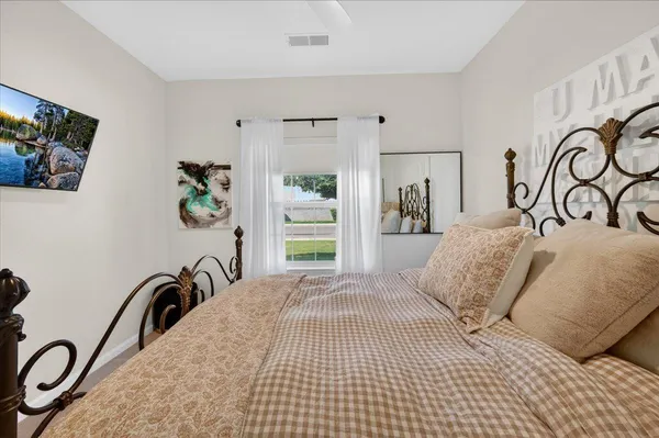 a view of a patio with table and chairs a barbeque with potted plants and floor to ceiling window