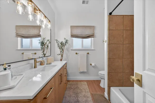 an aerial view of a house with garden space and street view