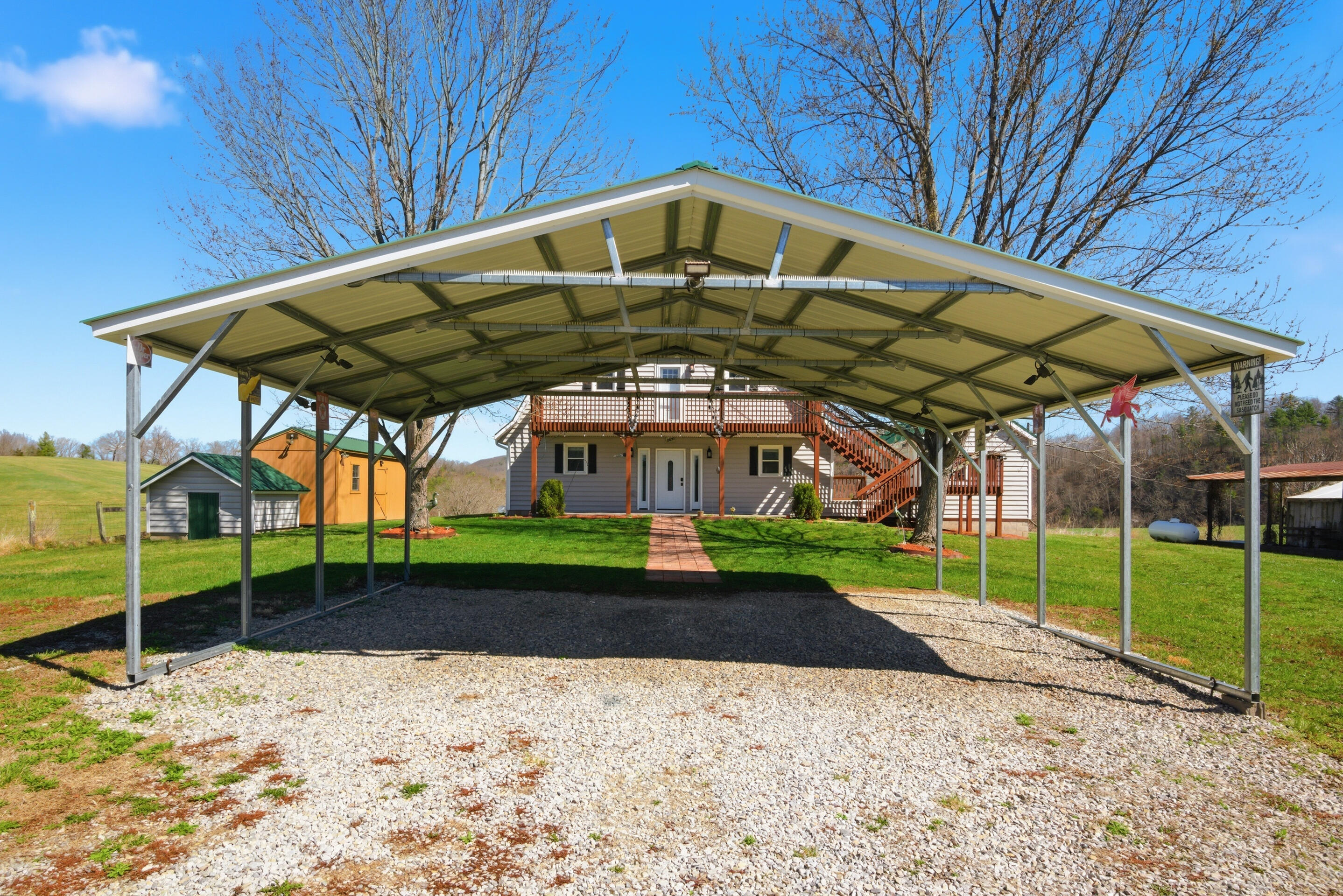 6458 Piney Woods Road Riner, VA 24149 - Photo 34 of 50 a view of a yard with a table and chairs under an umbrella