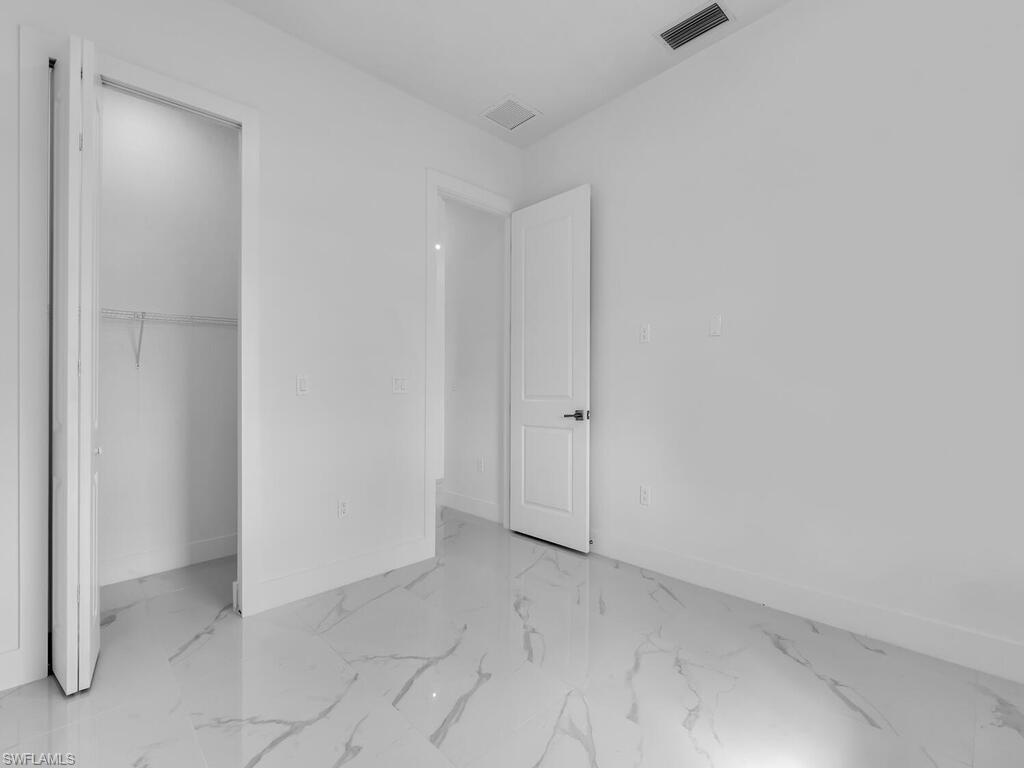 6108 Stratton Road Fort Myers, FL 33905 - Photo 19 of 27 Unfurnished bedroom featuring marble finish floors and a closet