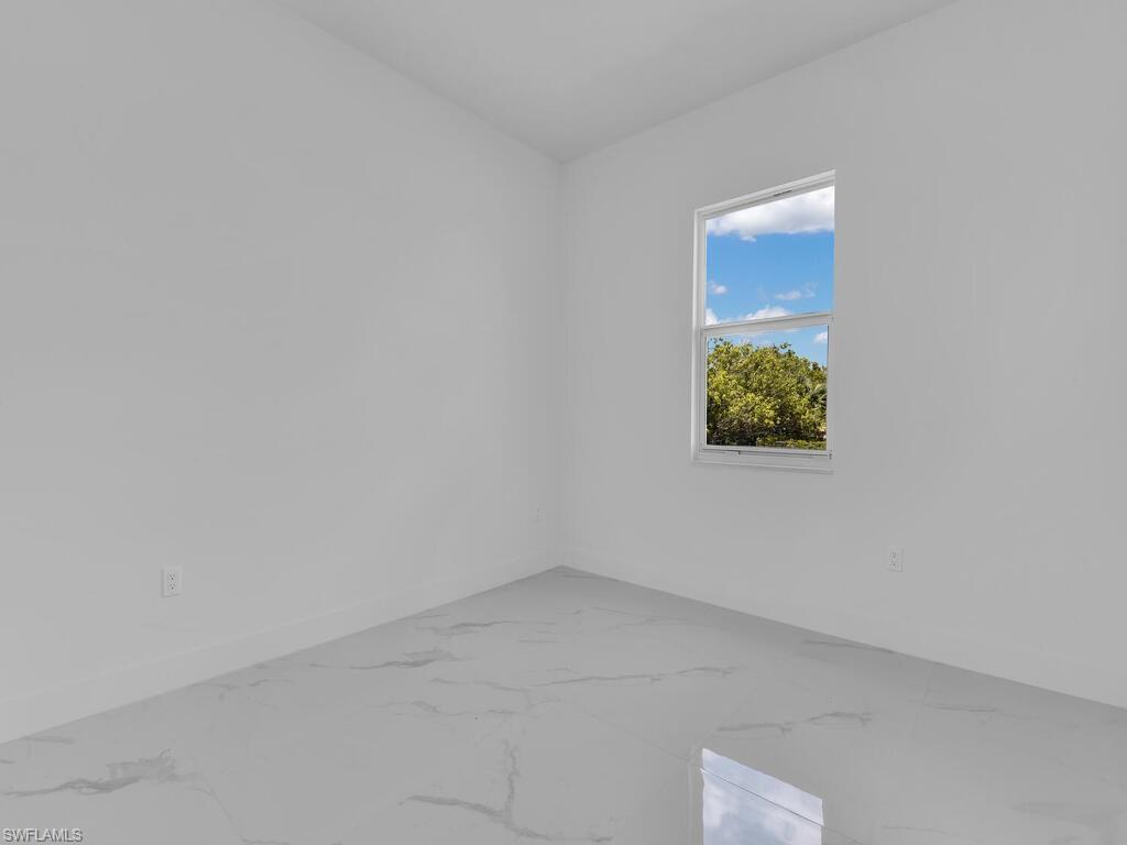 6108 Stratton Road Fort Myers, FL 33905 - Photo 22 of 27 Empty room with marble finish flooring and baseboards