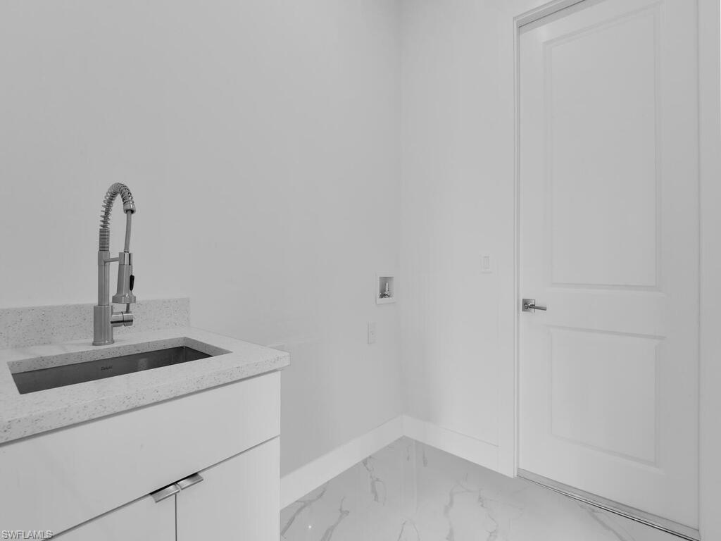 6108 Stratton Road Fort Myers, FL 33905 - Photo 26 of 27 Laundry area with light marble finish flooring, cabinet space, and hookup for a washing machine